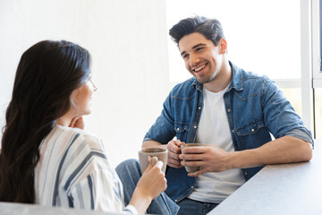Attractive young couple drinking coffee