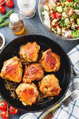 Delicious fried chicken thighs in a cast iron skillet