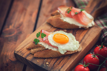 Poached egg and ham on toast for the breakfast
