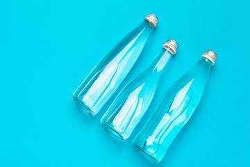 Blank water bottle on blue background top view
