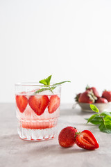 Refreshing summer drink. Ice tea, lemonade with Strawberry in glass on white background. Copy space