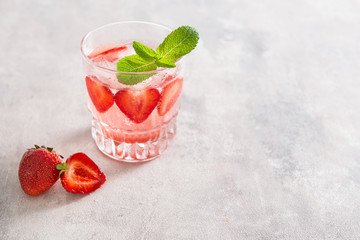 Refreshing Ice Cold Strawberry Lemonade on a grey background. Copy space