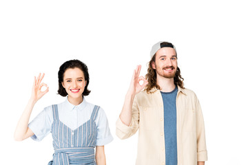 young man and girl showing Ok signs at camera isolated on white