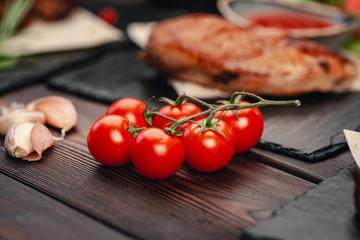Fresh red tomatoes on background or light rustic table. Tomato variety