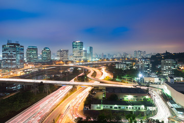 Fototapeta na wymiar City skyline and traffic on highway at night, Sao Paulo, Brazil