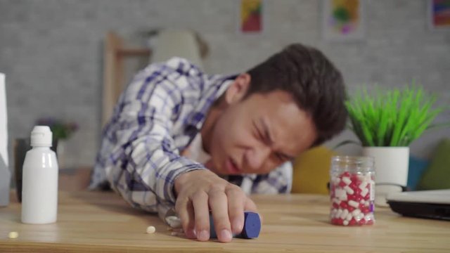 dramatic shot young asian man in a shirt asthmatic with attacks of suffocation uses an inhaler