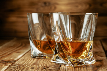 Cognac or whiskey in glasses on rustic backgrpund