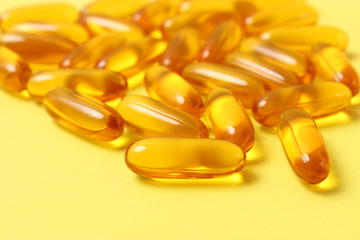 Omega-3 capsules on a colored background. Fish oil, healthy supplements