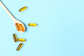 Omega-3 capsules on a colored background. Fish oil, healthy supplements