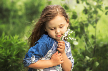 girl with lily of the valley in nature