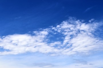 Beautiful white fluffy cloud formations on a deep blue sky