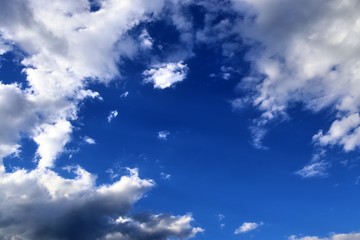 Beautiful white fluffy cloud formations on a deep blue sky
