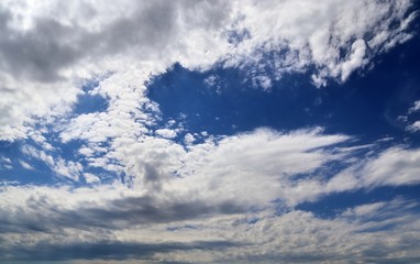 Beautiful white fluffy cloud formations on a deep blue sky
