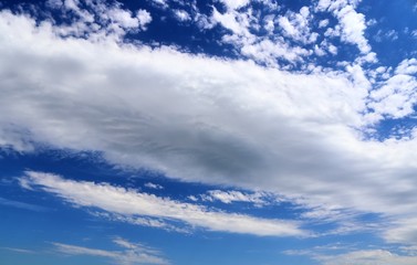 Beautiful white fluffy cloud formations on a deep blue sky