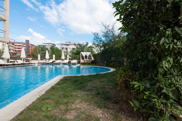Summer vacation. Swimming pool of luxury hotel with umbrella and chair around. Hotel resort in Bulgaria, Primorsko for travel