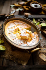 Homemade casserole, pudding, cheesecake, tart, pie or mousse cut into slices in oval glass baking dish