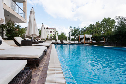 Summer vacation. Swimming pool of luxury hotel with umbrella and chair around. Hotel resort in Bulgaria, Primorsko for travel