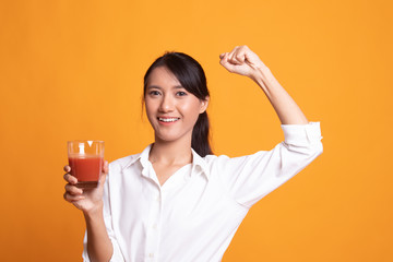 Strong healthy Asian woman with tomato juice.