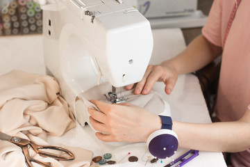 woman sews tailor fashion designer sewing machine