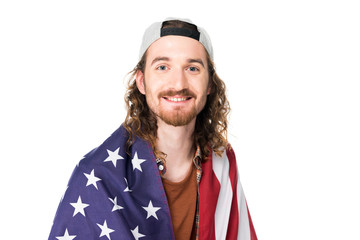 portrait shot of young handsome man with American flag on shoulders, looking at camera isolated on white