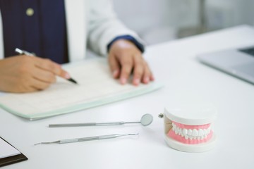 Dentist examining a patient teeth medical treatment at the dental office
