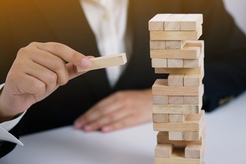 .Planning risk and strategy in businessman gambling placing wooden block.Business concept for...