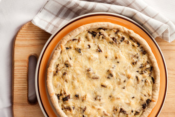Chicken tart with mushrooms and cheese on a plate
