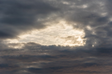 Dark Cloudscape at Sunset with a Hole in the Sky