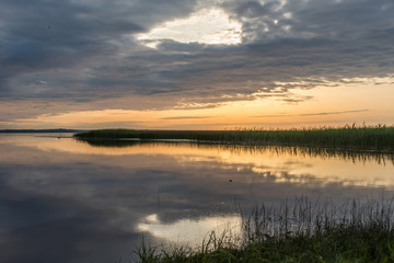 A Still Lake in Rural Latvia at Sunset