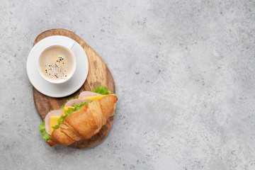 Coffee and croissant sandwich