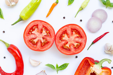 Various fresh vegetables and herbs on white background.