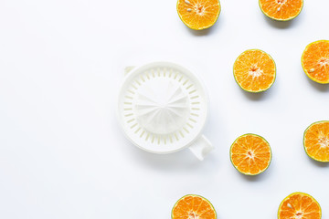 Citrus orange juicer with half-cut oranges on white background.