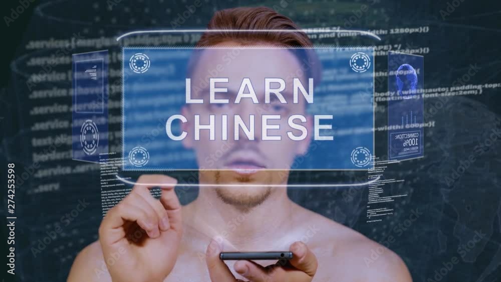 Wall mural young man interacts with a conceptual hud hologram with text learn chinese. guy with future technolo