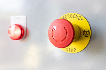 close-up of emergency button and red light button on gray steel