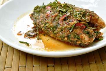batter fried mango fish dressing spicy herb sauce on plate