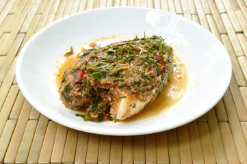 batter fried mango fish dressing spicy herb sauce on plate