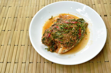 batter fried mango fish dressing spicy herb sauce on plate