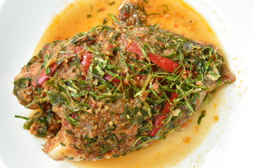 batter fried mango fish dressing spicy herb sauce on plate