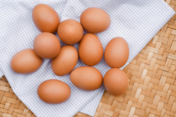 Brown eggs lay on a white plaid fabric. Healthy food concepts.