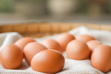 Close-up brown eggs lay on a plaid fabric. Healthy food concepts.