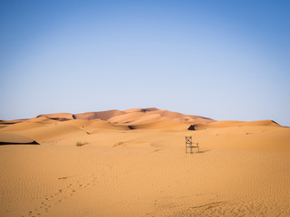Fototapeta na wymiar Chair on a Sand Dune in the Sahara Desert