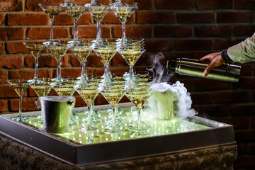 pyramid line of alcohol cocktails on open party wedding table