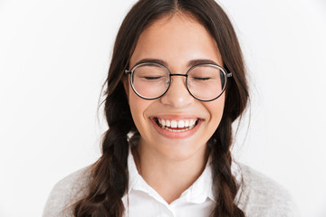Portrait closeup of happy teenage girl wearing eyeglasses and school uniform laughing with eyes closed