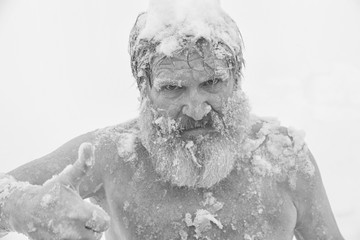 Bearded man, after bathing in the snow