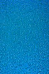 Small liquid drops on a blue background