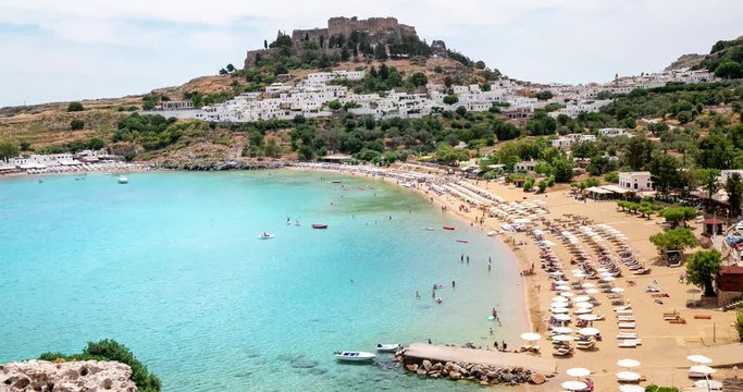 Timelapse video of famous tourist attraction of Lindos town and resort beach bay on Rhodes island. Travel and tourism in Greece