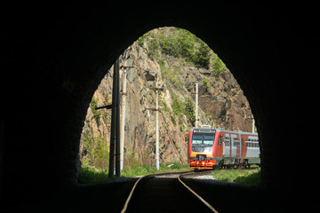 An electric train enters the tunnel