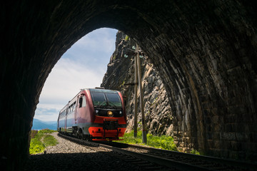 An electric train enters the tunnel - obrazy, fototapety, plakaty