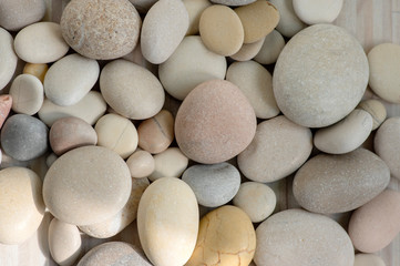 Group of white, grey and light brown stones background, pebbles beach