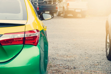 ฺBlack side of Yellow-green cars parked on the ground. or Taxi for transportation business at upcountry.